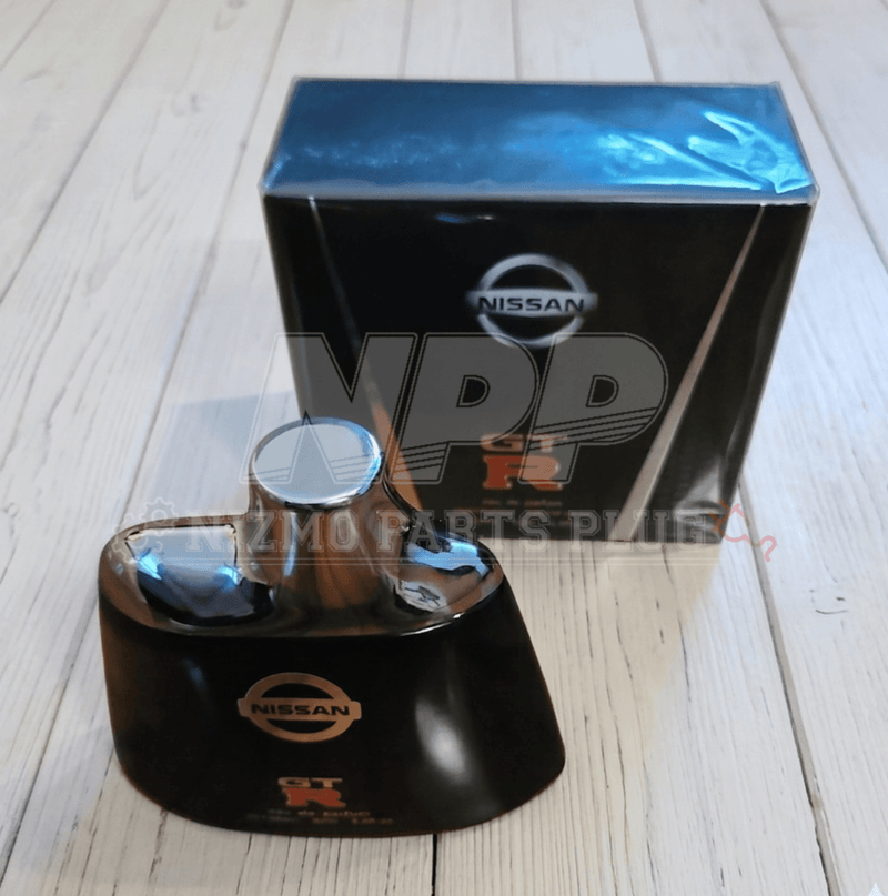 Load image into Gallery viewer, Nissan GTR Eau de Parfum cologne in black bottle with silver cap and branded box, sitting on white wooden surface.