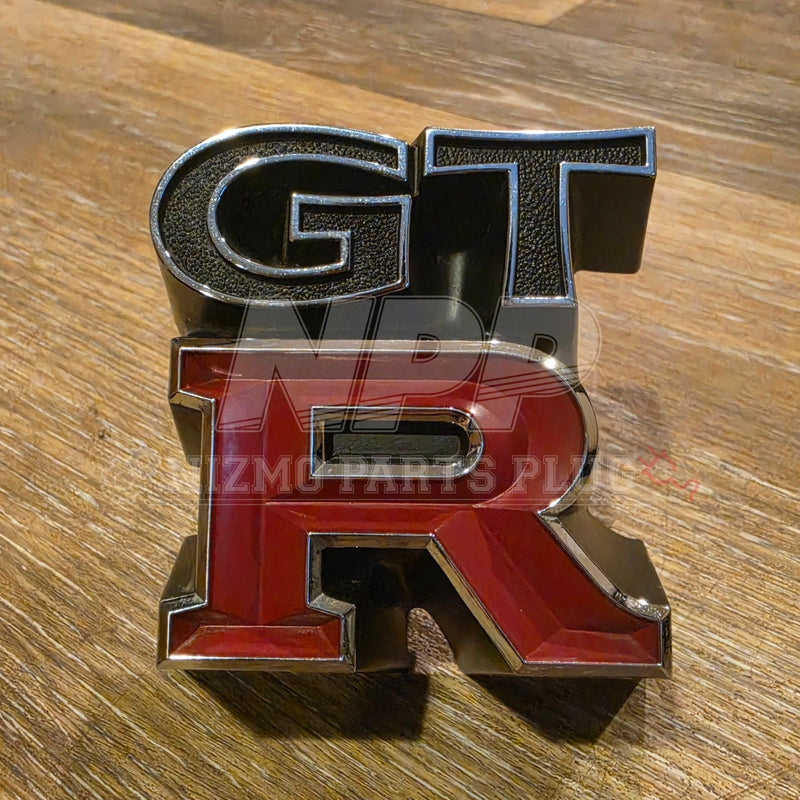 Load image into Gallery viewer, Rare OEM Used Nissan Skyline GT-R (KPGC110) "Kenmeri" Front Grille Emblem – 62319-R4800