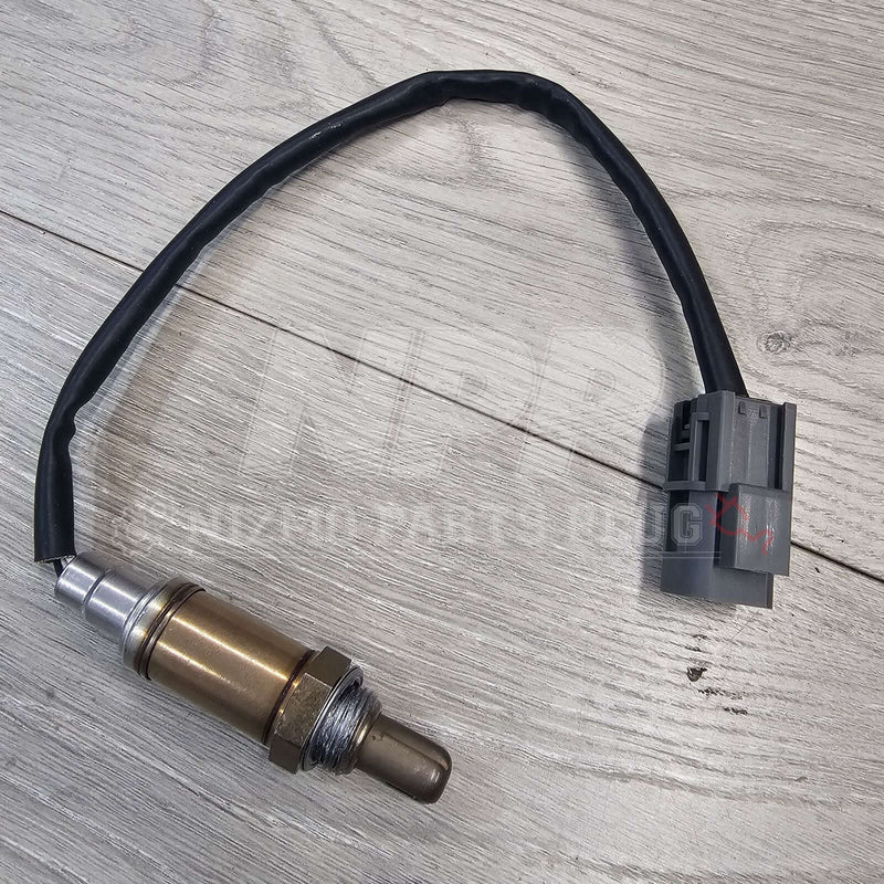 Load image into Gallery viewer, Nissan R33/34 Skyline GTR front O2 oxygen sensor with a black wire and grey connector on a wood background.