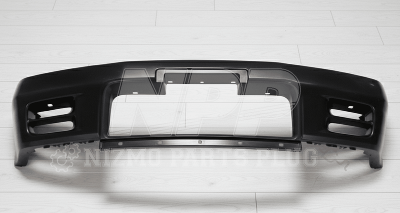 Load image into Gallery viewer, New black Nissan R32 Skyline GTR front bumper assembly on a light wood floor background.