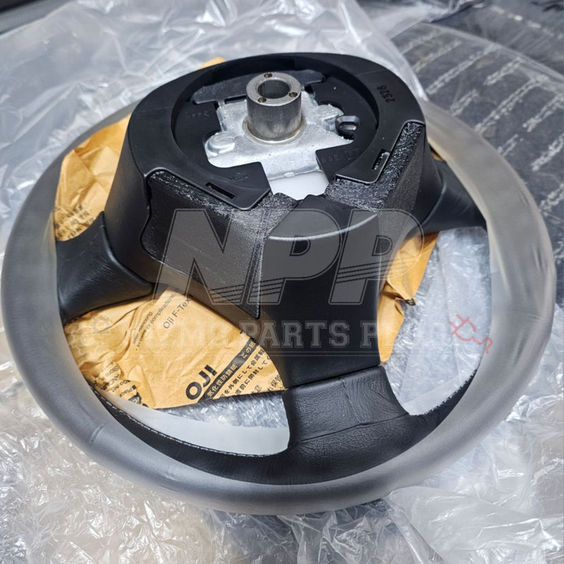 Load image into Gallery viewer, New black Nissan R34 Skyline/S15 Silvia steering wheel access cover set in plastic packaging.