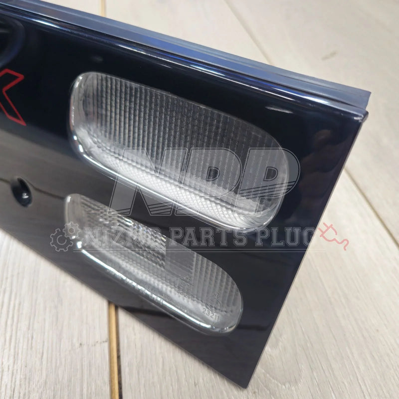 Load image into Gallery viewer, Close-up of a black license plate with clear lens lights on a wooden surface