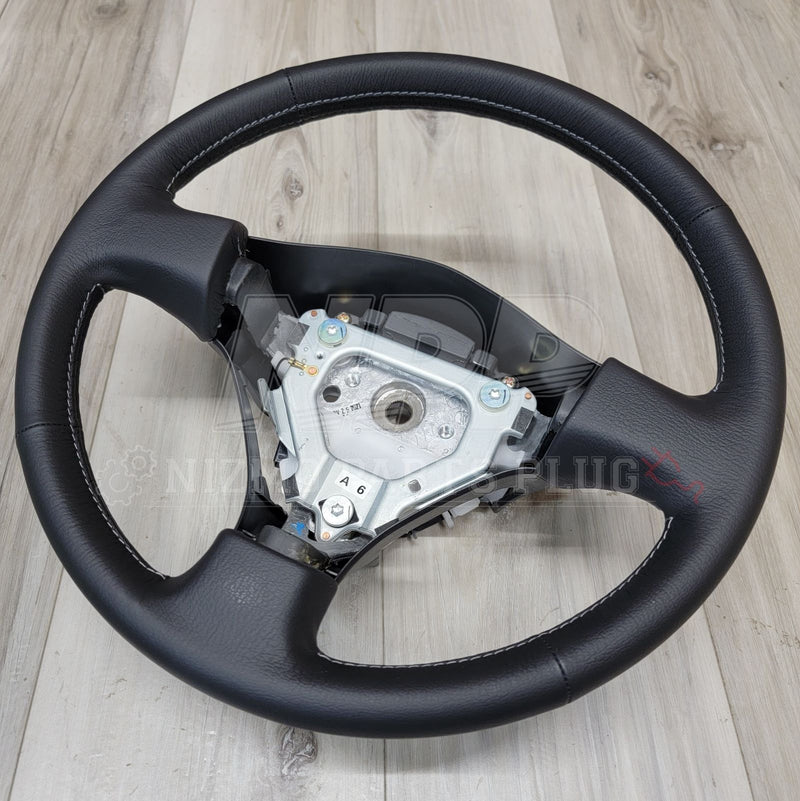 Load image into Gallery viewer, Nissan R34 Skyline GTR V-Spec Steering Wheel Assembly - NizmoPartsPlug