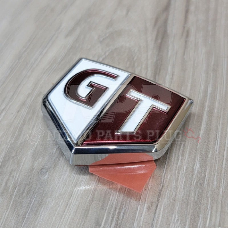 Load image into Gallery viewer, Nissan R34 Skyline GTT Fender Emblem (Red/White) - NizmoPartsPlug