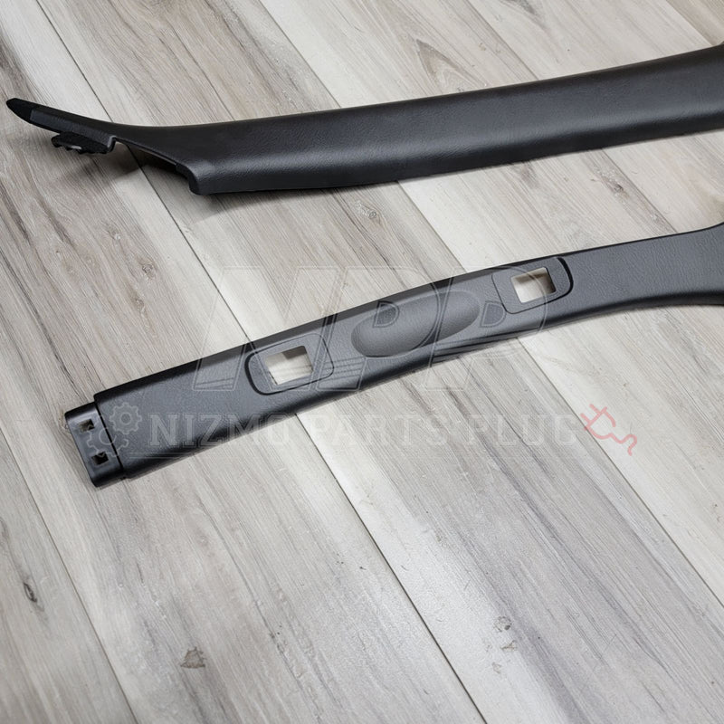 Load image into Gallery viewer, Black Nissan R34 Skyline coupe interior A-pillar garnish set in excellent condition on a wood-grain background.