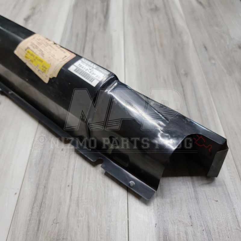ギャラリービューアに画像をロードする, New Nissan S13 240SX black metal lower rocker panel with OEM part label on a wood-grain surface.