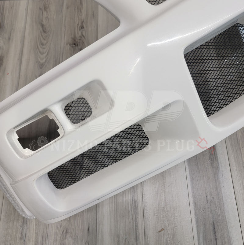 Load image into Gallery viewer, White Nismo S-Tune front bumper assembly for Nissan R34 Skyline GTR with black mesh inserts.