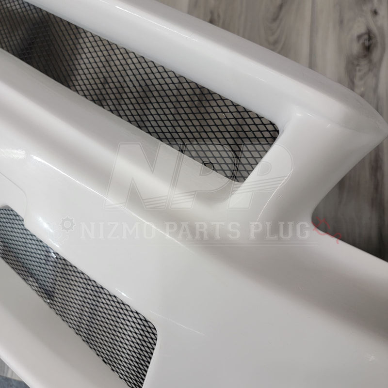 Load image into Gallery viewer, White Nismo S-Tune front bumper for Nissan R34 Skyline GTR, featuring integrated black mesh grille inserts.