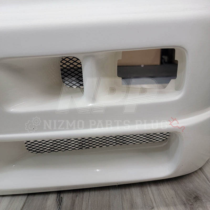 Load image into Gallery viewer, White Nissan R34 Skyline GTR Nismo S-Tune front bumper with black mesh intake grilles.