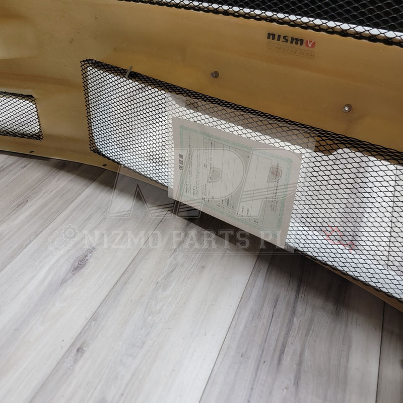 Load image into Gallery viewer, Tan Nissan R34 GTR Nismo S-Tune front bumper with black mesh, Nismo branding, and original warranty certificate.