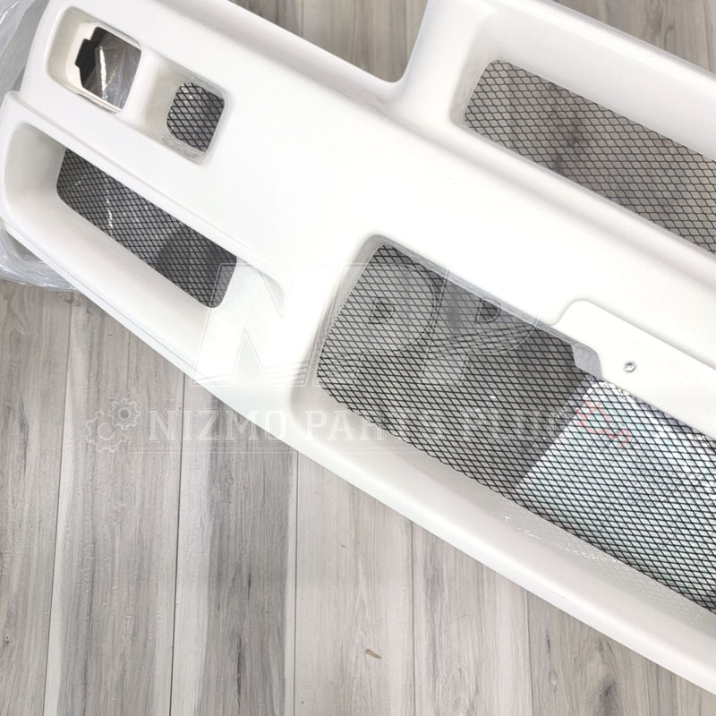 Load image into Gallery viewer, White Nismo S-Tune front bumper for Nissan R34 GTR with black mesh inserts, viewed from above.