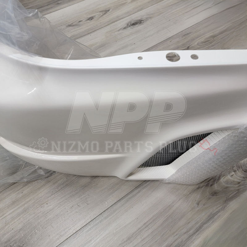 Load image into Gallery viewer, White Nissan R34 GTR Nismo S-Tune front bumper, new condition, featuring a black mesh intake.