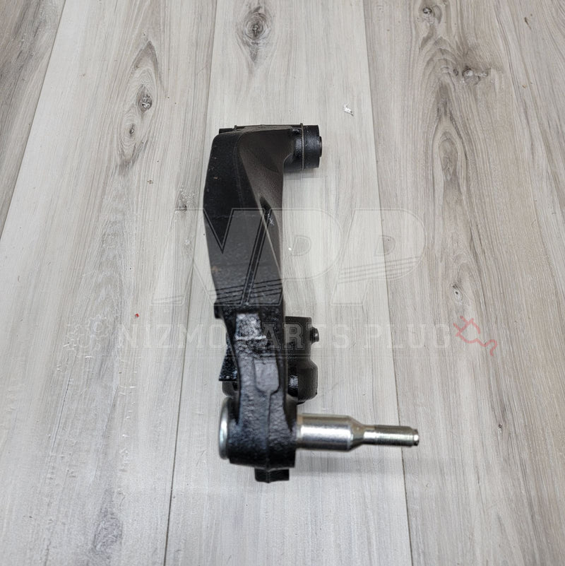 Load image into Gallery viewer, Black R33/R34 GTR front extension knuckle arm, clean condition, isolated on a light wood grain background.