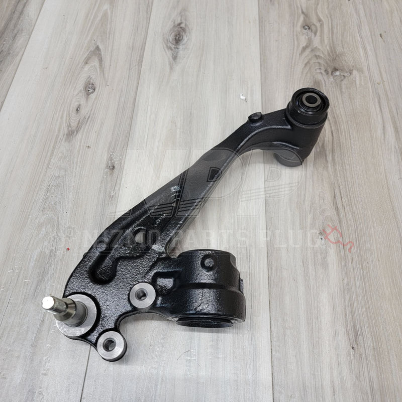 Load image into Gallery viewer, Black R33/R34 GTR front extension knuckle arm in excellent condition, isolated on a light wood grain background.