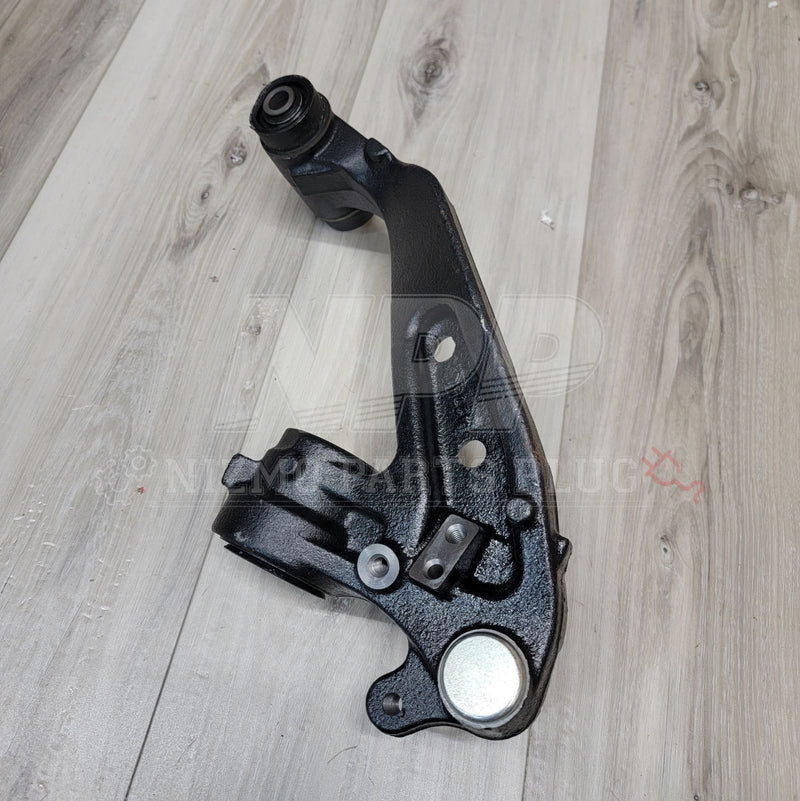 Load image into Gallery viewer, Black Nissan R33/34 GTR front extension knuckle arm, clean condition, isolated on wood grain background.