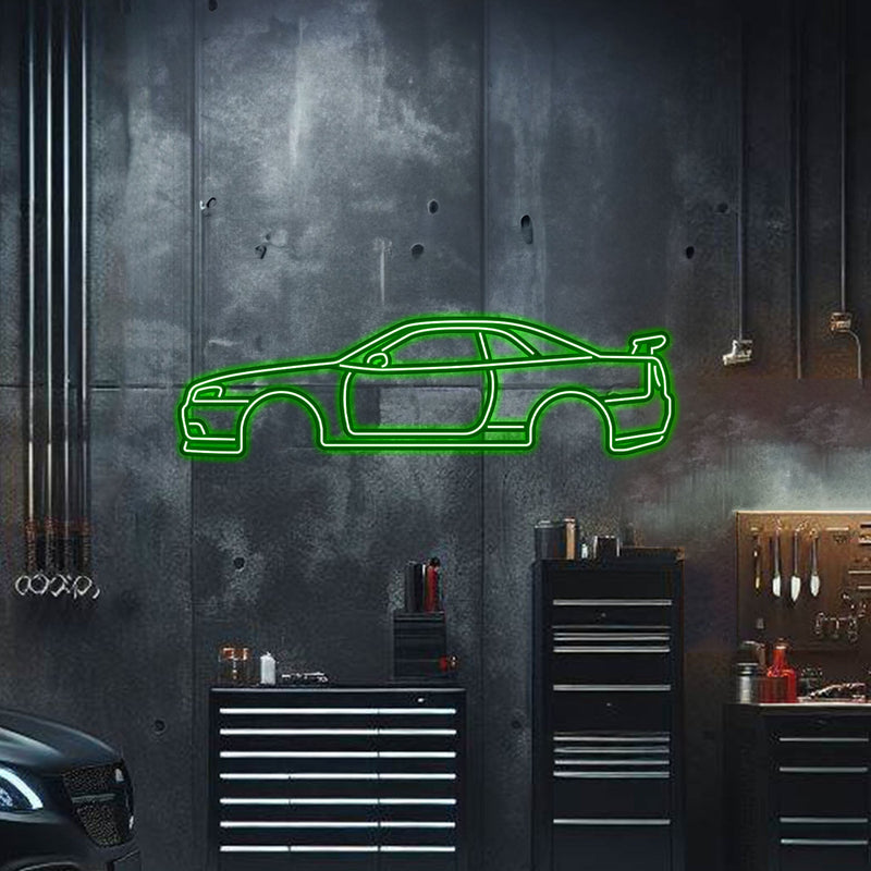 Load image into Gallery viewer, Green neon metal wall art of a Nissan Skyline GT-R R34 side profile silhouette, displayed in a garage setting.