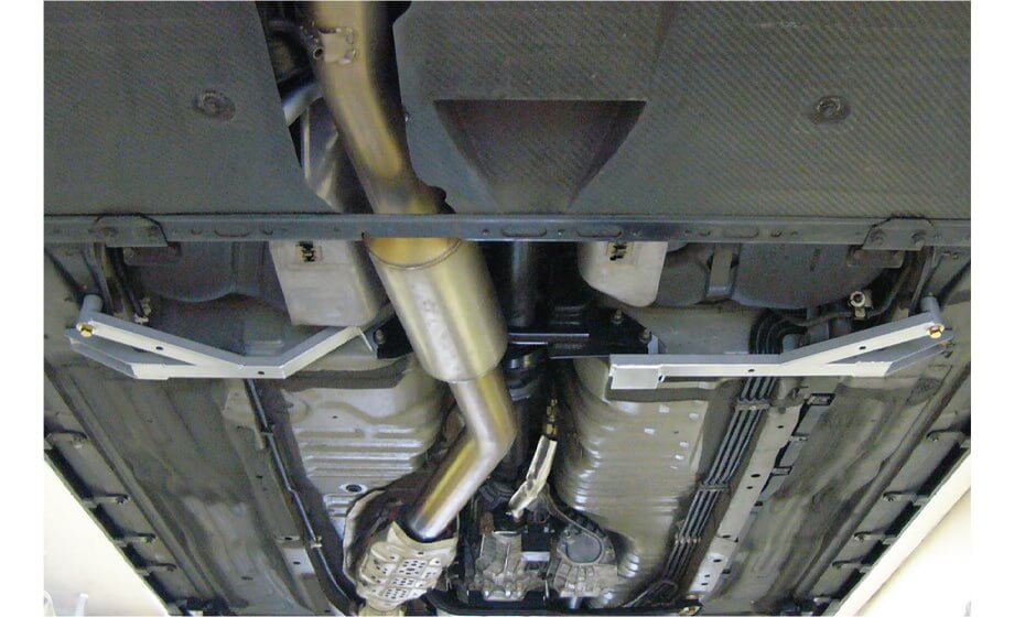 Nismo BNR34 GTR Center Floor Reinforcement Bar Assembly installed on vehicle underside for improved rigidity.