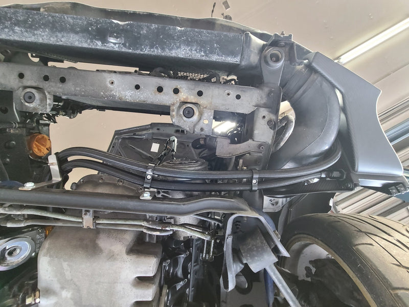 Load image into Gallery viewer, Complete U.P.G oil cooler with black carbon fiber ducting installed on an R32 GTR chassis.
