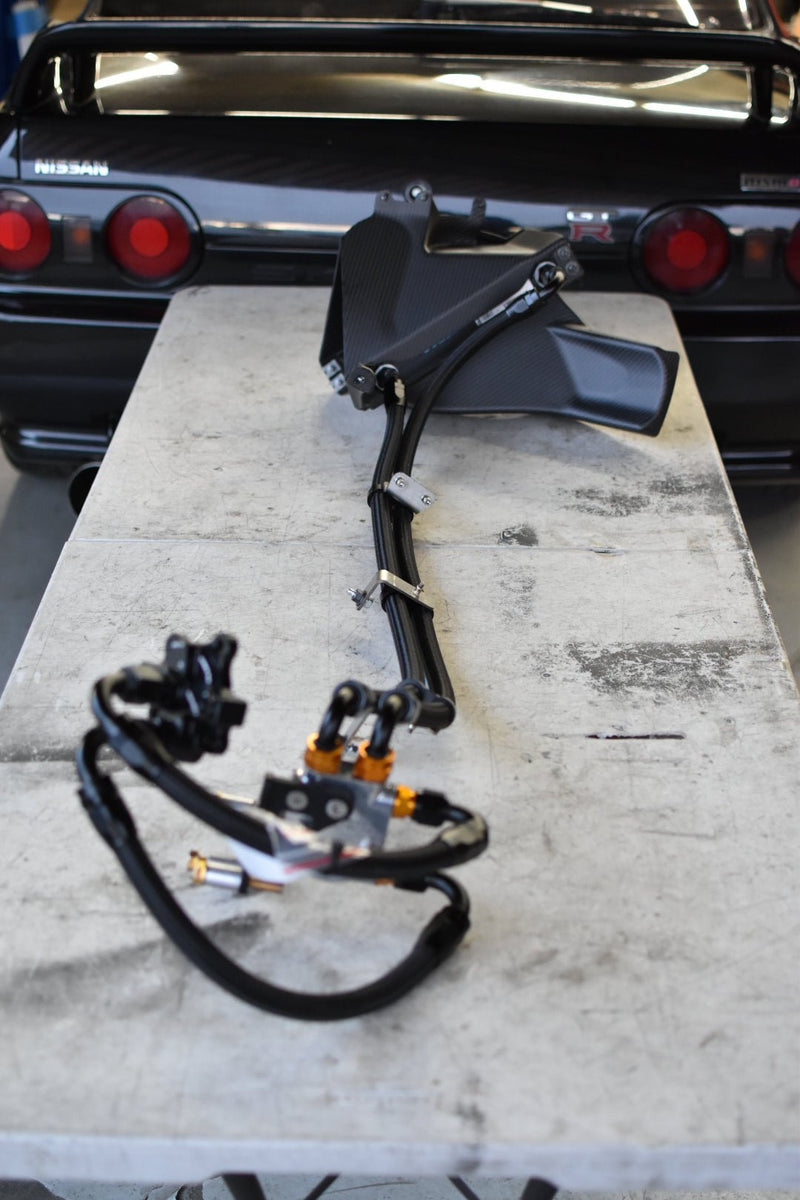 Load image into Gallery viewer, Complete U.P.G oil cooler kit with carbon fiber ducting for Nissan R32 GTR, featuring black hoses and gold fittings.