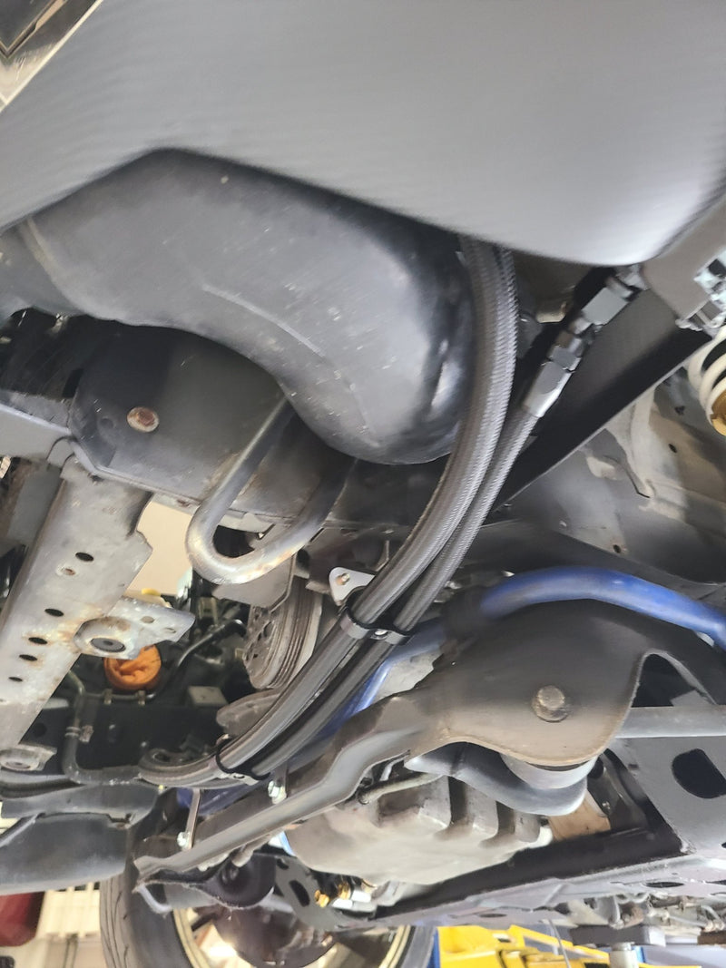 Load image into Gallery viewer, Complete U.P.G oil cooler with black carbon ducting installed under the chassis of a Nissan R32 GTR.