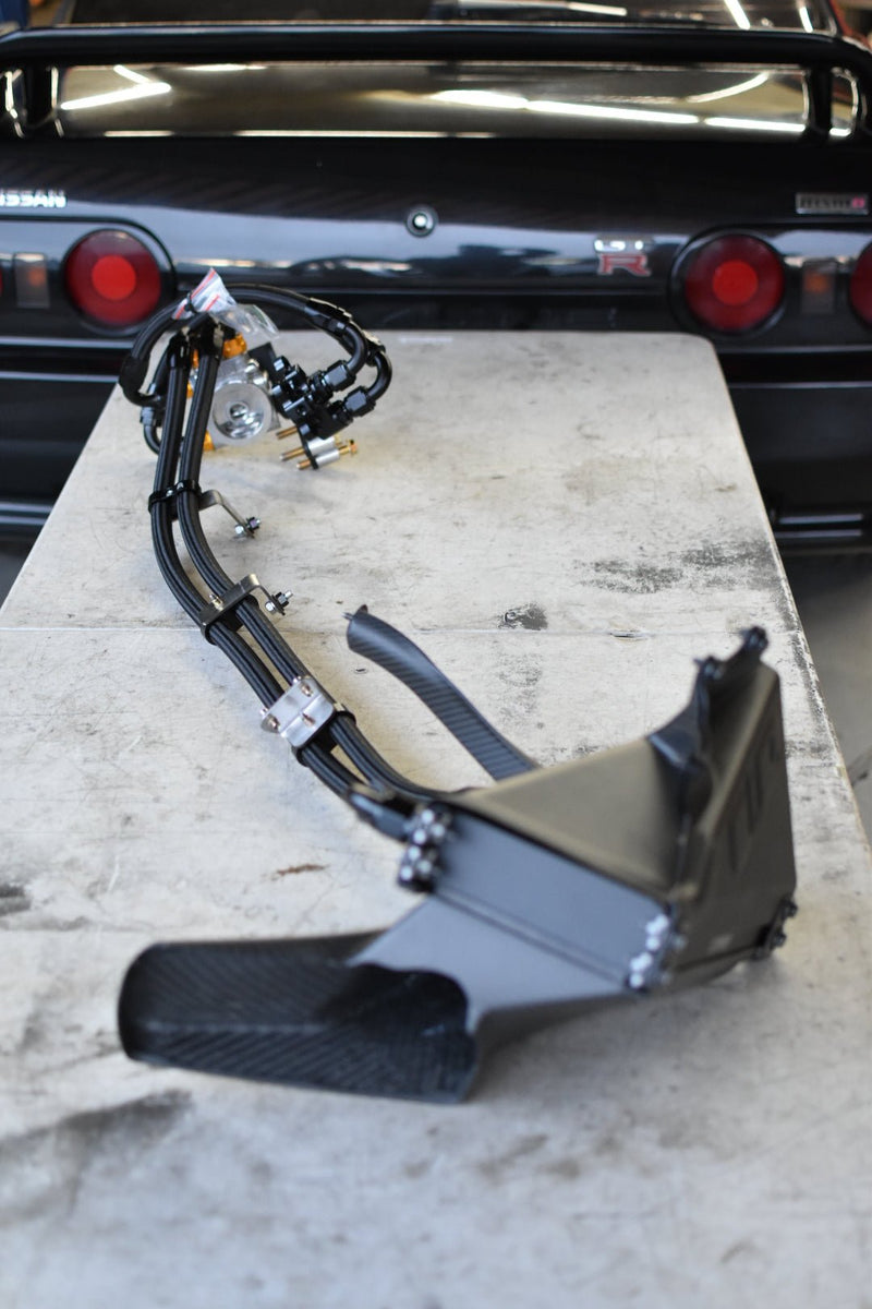 Load image into Gallery viewer, Complete U.P.G oil cooler kit with carbon ducting for Nissan R32 GTR on a workbench in front of a GTR.