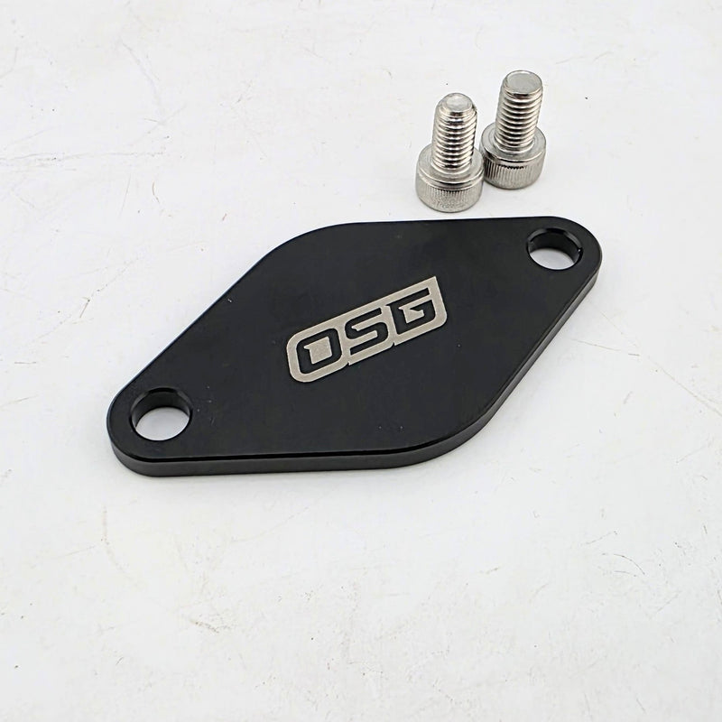 Load image into Gallery viewer, Black aluminum Toyota 2JZ IACV block off plate with "OSG" logo and two mounting bolts on a white surface.