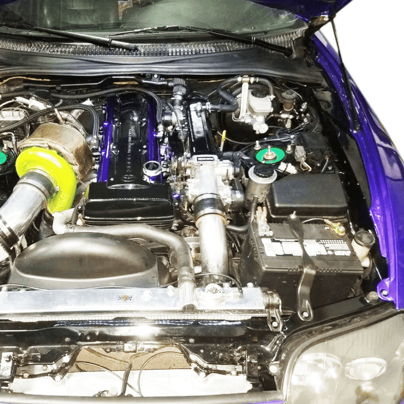 Load image into Gallery viewer, ZSPEC stainless and billet bolt kit installed in a Toyota Supra MKIV engine bay with purple and silver hardware.