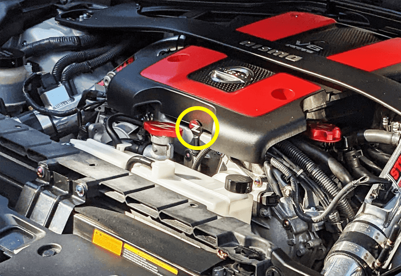 Load image into Gallery viewer, ZSPEC black billet aluminum dipstick handle on a Nissan 370z (Z34) engine, highlighted by a yellow circle.