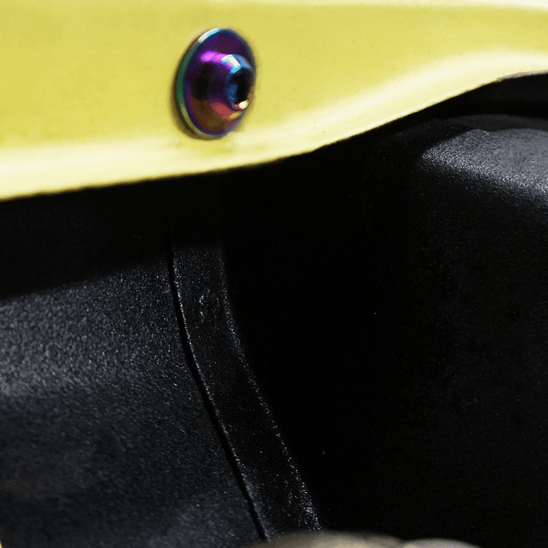 Cargue la imagen en el visor de la galería, Iridescent titanium ZSPEC dress-up bolt installed on a yellow '70-78 Datsun S30 chassis.