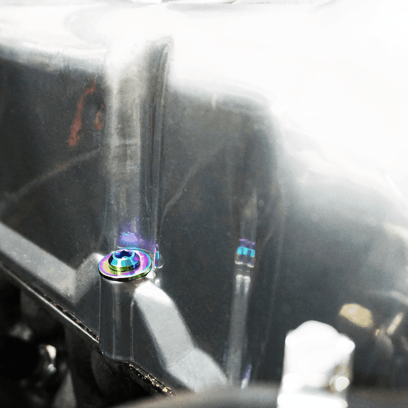 Load image into Gallery viewer, Titanium ZSPEC dress-up bolt installed on a 1970-78 Datsun S30 valve cover, featuring a rainbow-anodized finish.