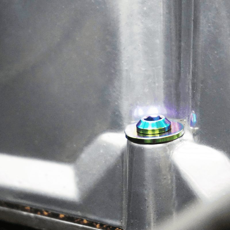 Load image into Gallery viewer, ZSPEC titanium valve cover fastener on a L-series Datsun engine, featuring a burnt, iridescent rainbow finish.