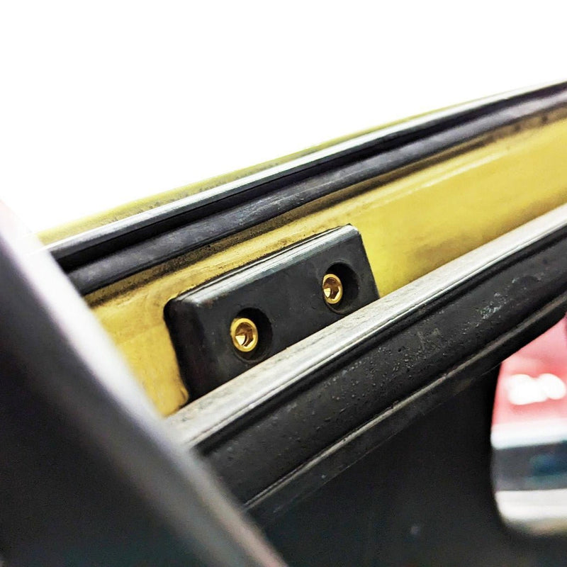 Load image into Gallery viewer, ZSPEC titanium trunk fastener kit installed on a Datsun S30. Shows gold bolts secured in a black rubber trim mount.