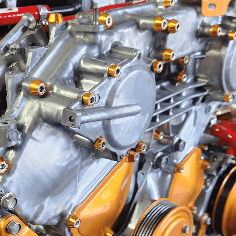 Load image into Gallery viewer, ZSPEC engine cover fastener kit installed on a VQ35DE engine, featuring polished components and gold billet washers.