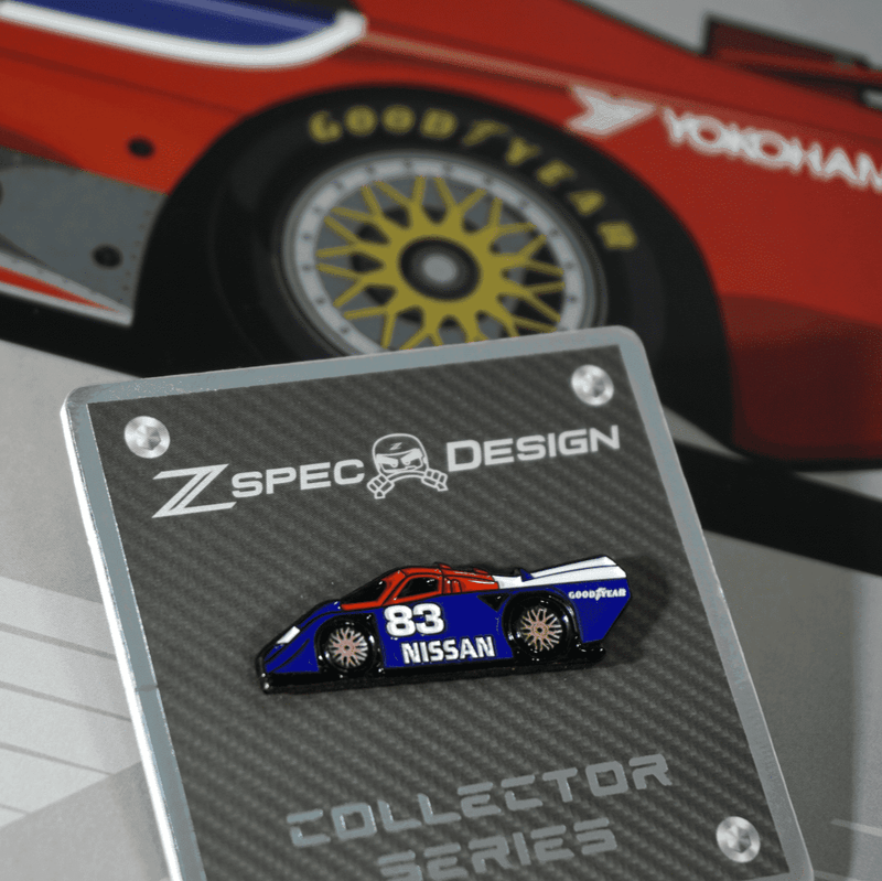 Load image into Gallery viewer, ZSPEC Nissan #83 GTP race car lapel pin in blue, red, and white on a carbon fiber display card.