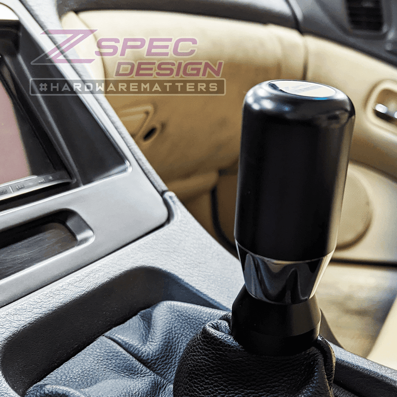 Load image into Gallery viewer, Black ZSPEC billet aluminum shift boot finisher installed on a Nissan Z/G/Q shift knob and leather boot.