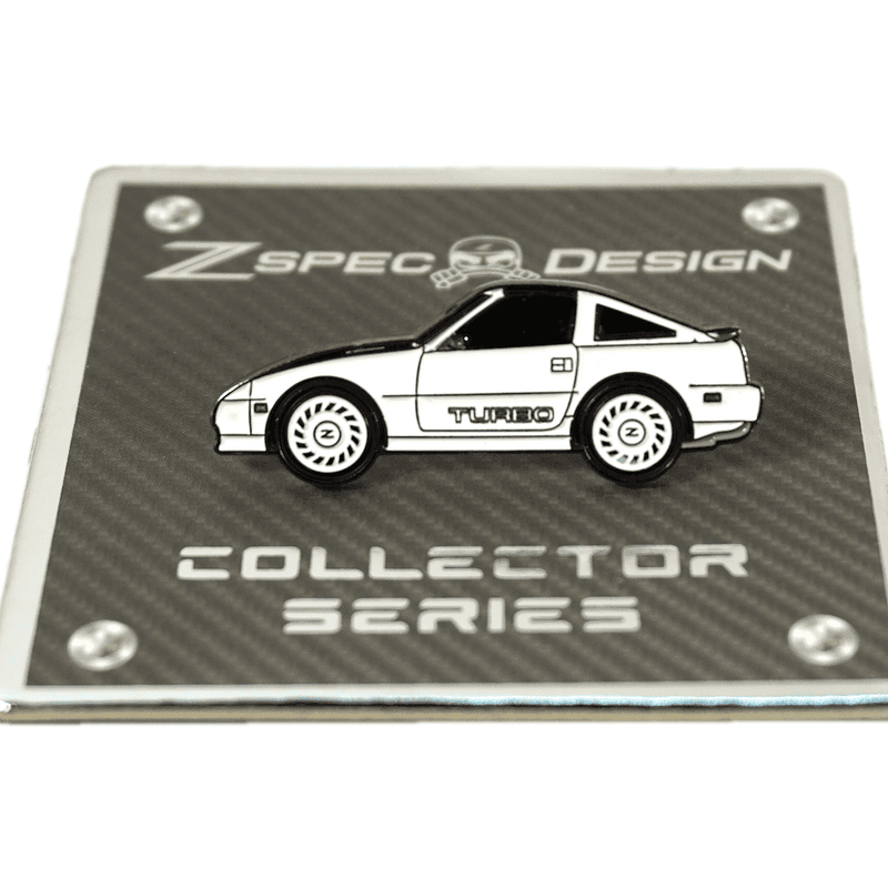 Load image into Gallery viewer, ZSPEC white Nissan 300ZX Z31 Shiro Turbo enamel lapel pin on a carbon fiber background Collector Series card.
