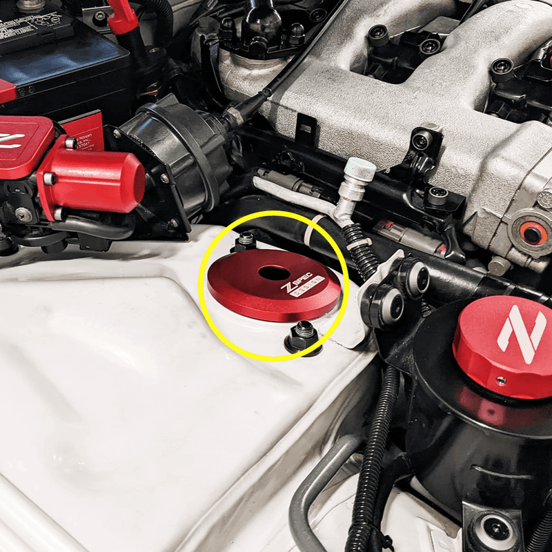 Load image into Gallery viewer, Red ZSPEC billet shock tower cover installed on a Nissan 300ZX Z32 engine bay, highlighted by a yellow circle.