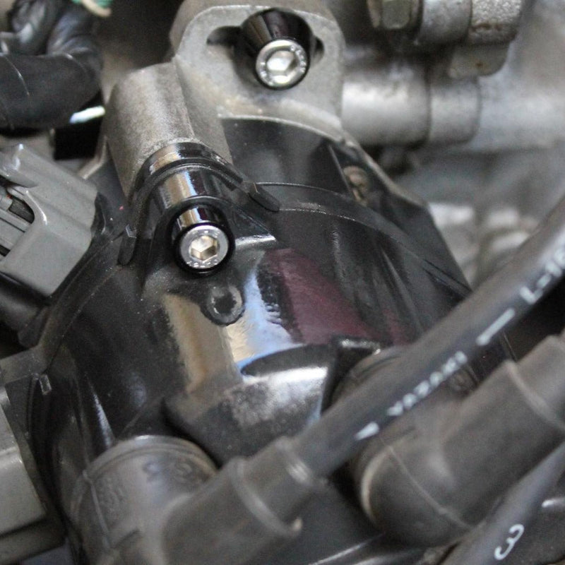 Load image into Gallery viewer, ZSPEC black billet dress-up bolts installed on a Nissan 240SX S14 engine component.