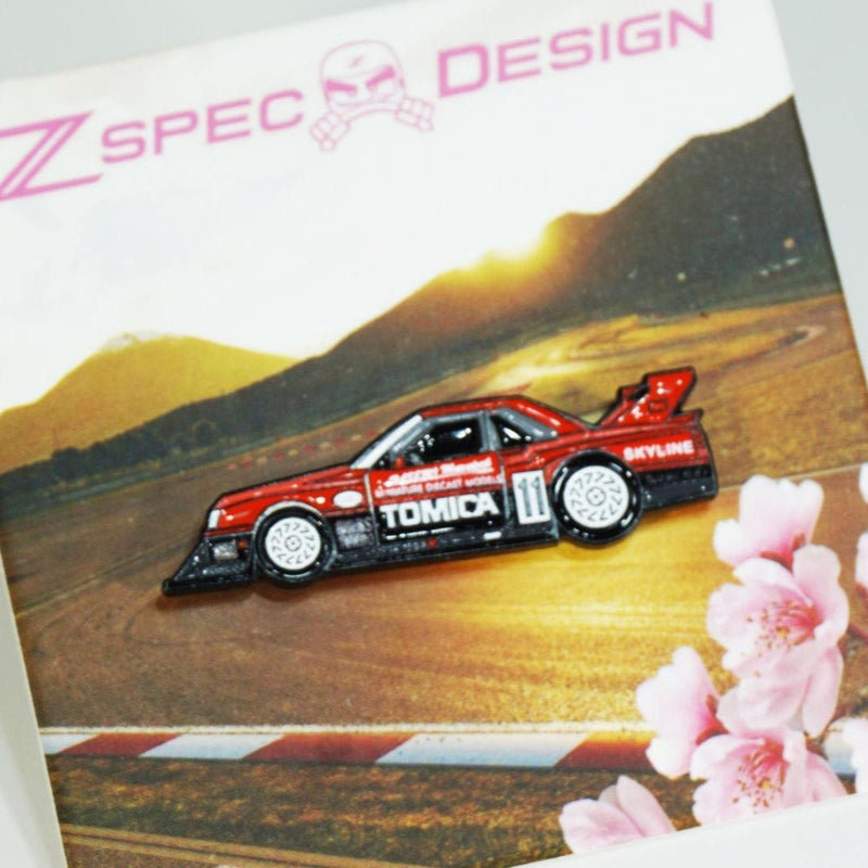 Load image into Gallery viewer, Red Nissan Skyline RS Silhouette Formula race car lapel pin featuring Tomica #11 livery on a mountain track card.