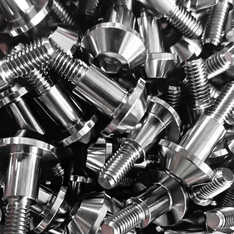 Load image into Gallery viewer, A pile of shiny, silver titanium valve cover bolts for Nissan/Infiniti VQ engines.