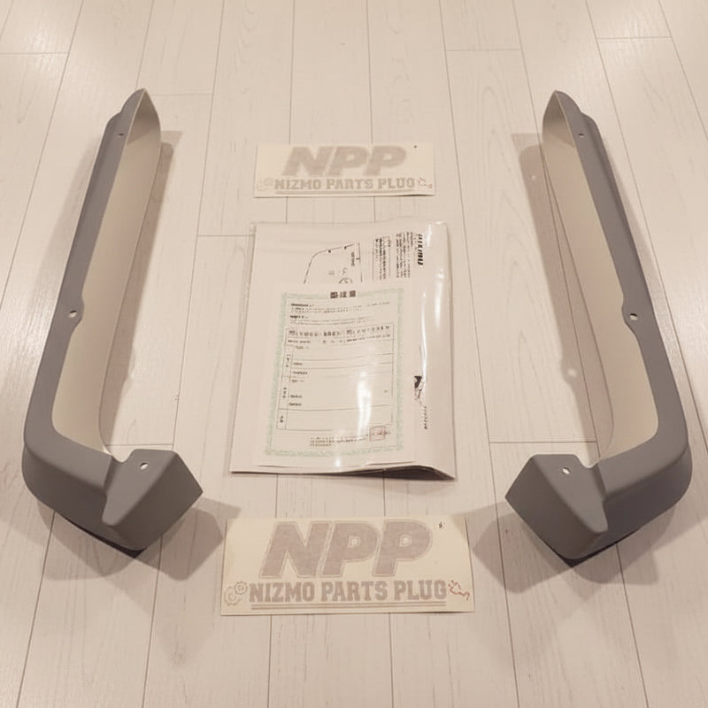 Load image into Gallery viewer, Grey Nismo S-Tune rear bumper under spoilers for Nissan R34 GTR, including original manual and documentation.