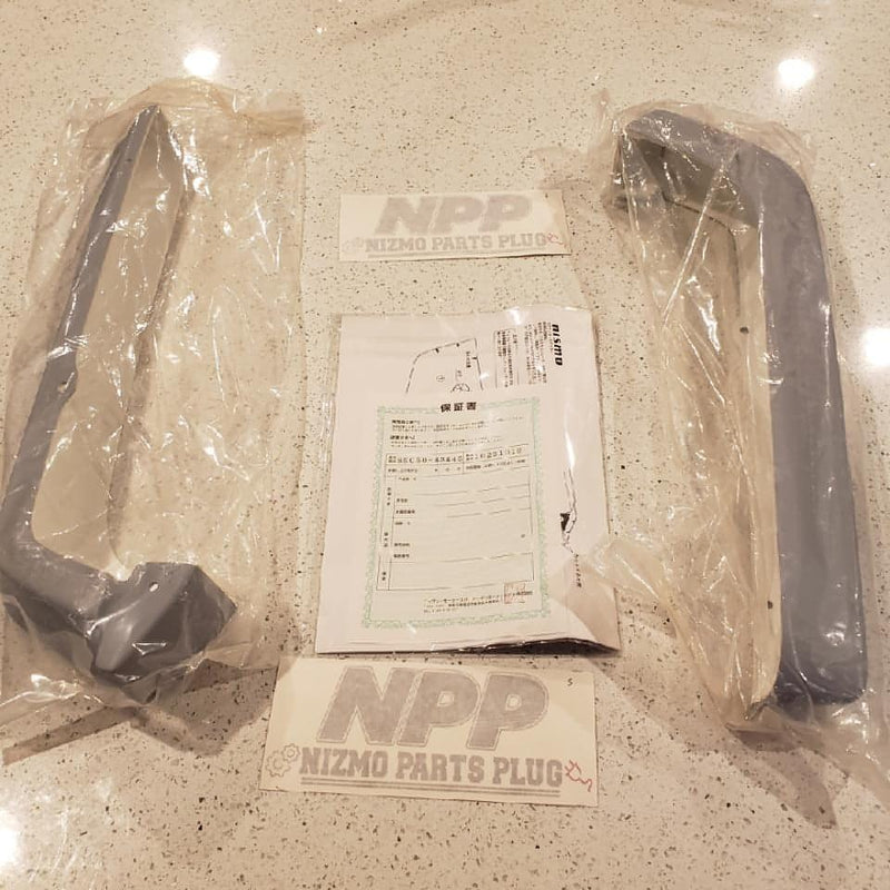 Load image into Gallery viewer, New, gray R34 GTR Nismo S-Tune rear bumper under spoiler set in original plastic packaging with documentation.