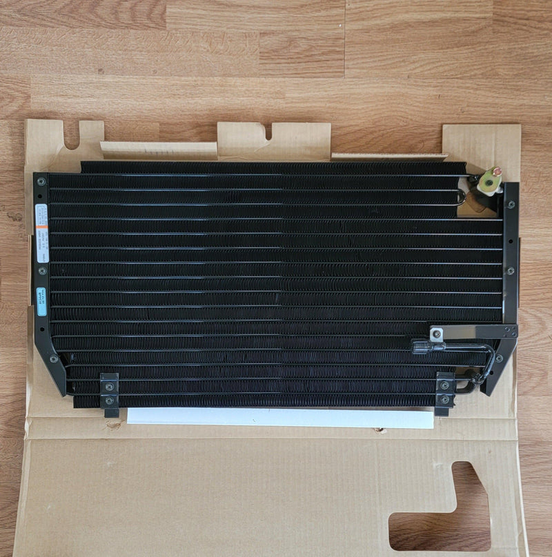 Load image into Gallery viewer, N.O.S. black A/C condenser for S13 240SX, new in original cardboard packaging.