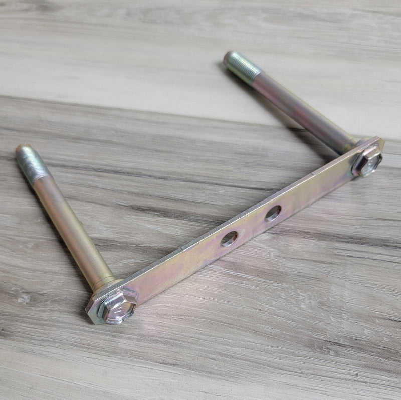 Load image into Gallery viewer, Nissan RWD front subframe bolt plate assembly with two zinc-coated threaded studs on a wood surface.