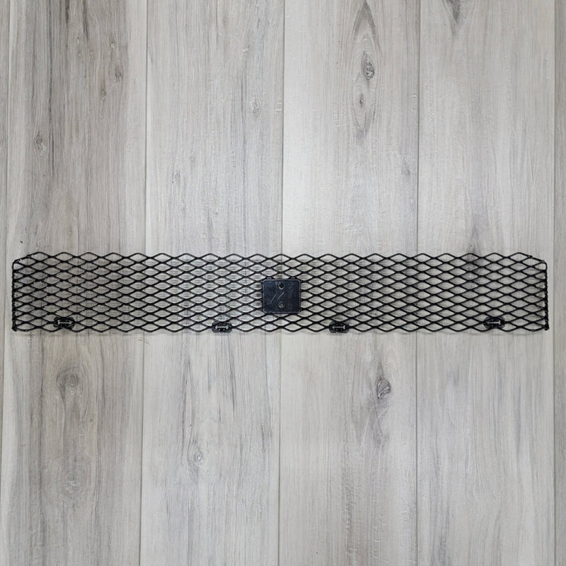 Load image into Gallery viewer, Black metal mesh front bumper upper grill for Nissan R34 GTR on light wood background.