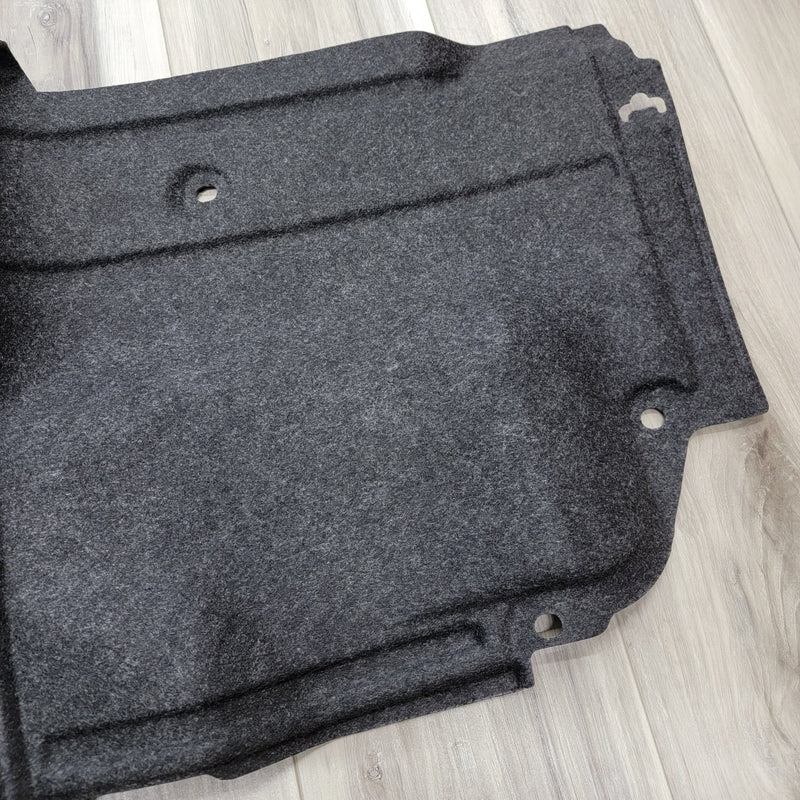 Load image into Gallery viewer, Dark grey felt R34 GTR LH trunk wheel housing interior trim finisher in clean condition.
