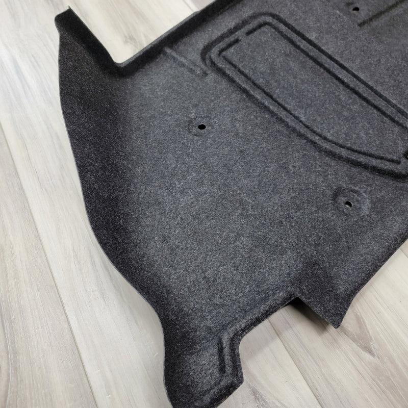 Load image into Gallery viewer, Black R34 GTR left-hand trunk wheel housing interior trim piece in clean, used condition.