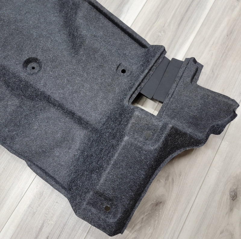 Load image into Gallery viewer, Clean grey R34 Skyline GTR trunk battery finisher panel on wood floor. Excellent used condition.
