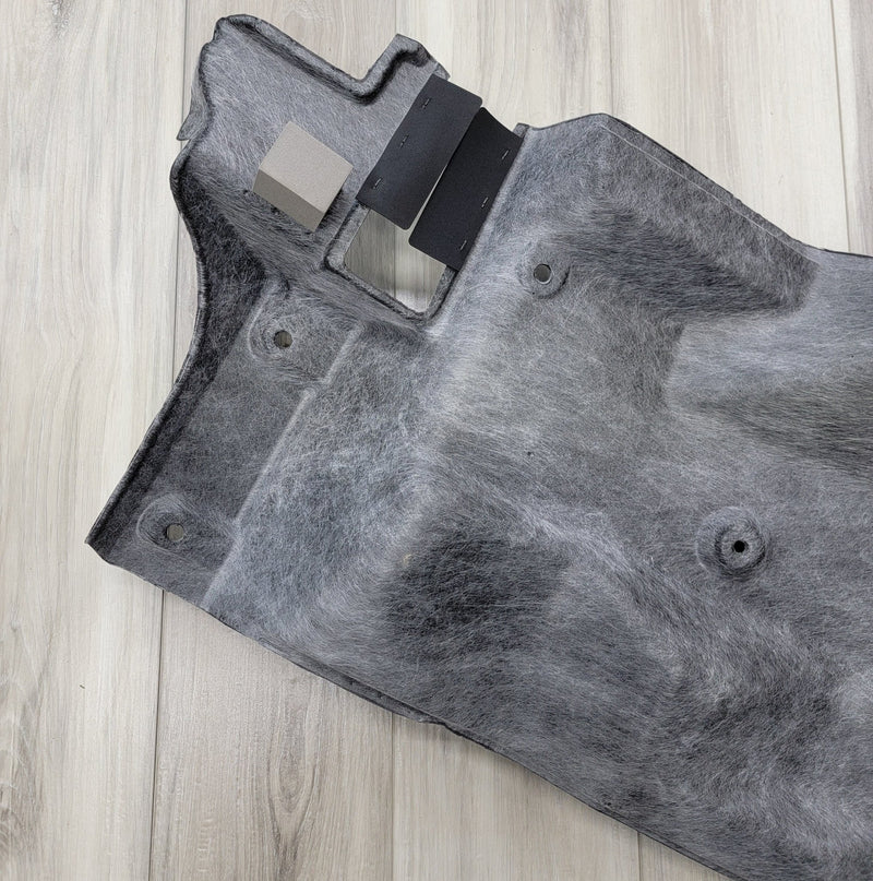 Load image into Gallery viewer, Grey R34 Skyline GTR trunk battery finisher panel with black trim pieces, shown on a wood floor.