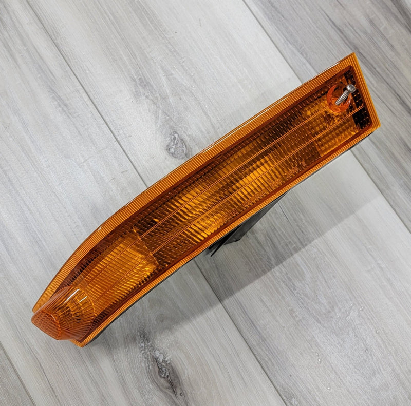 Load image into Gallery viewer, S14 Kouki JDM amber left-hand turn signal lamp assembly in good, clean condition on a wood-grain surface.